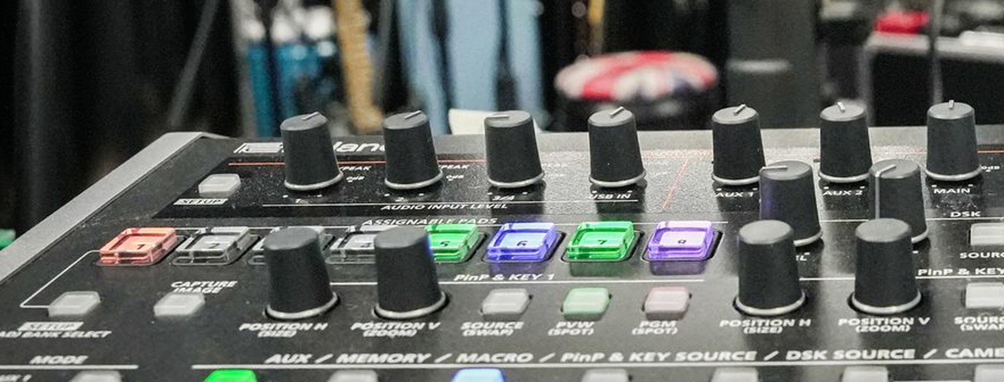 The source-select row of a switcher, aux and key labels legible