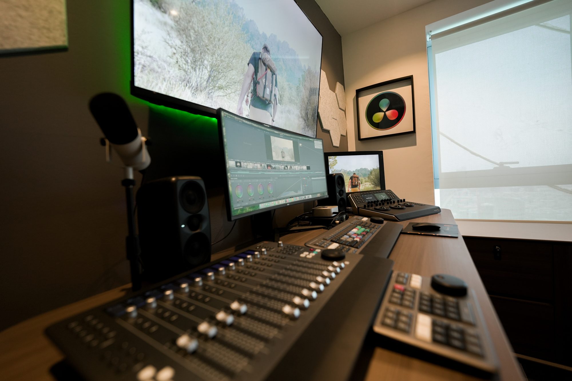 The Fairlight bench at MCX, faders in the foreground and the reference display beyond