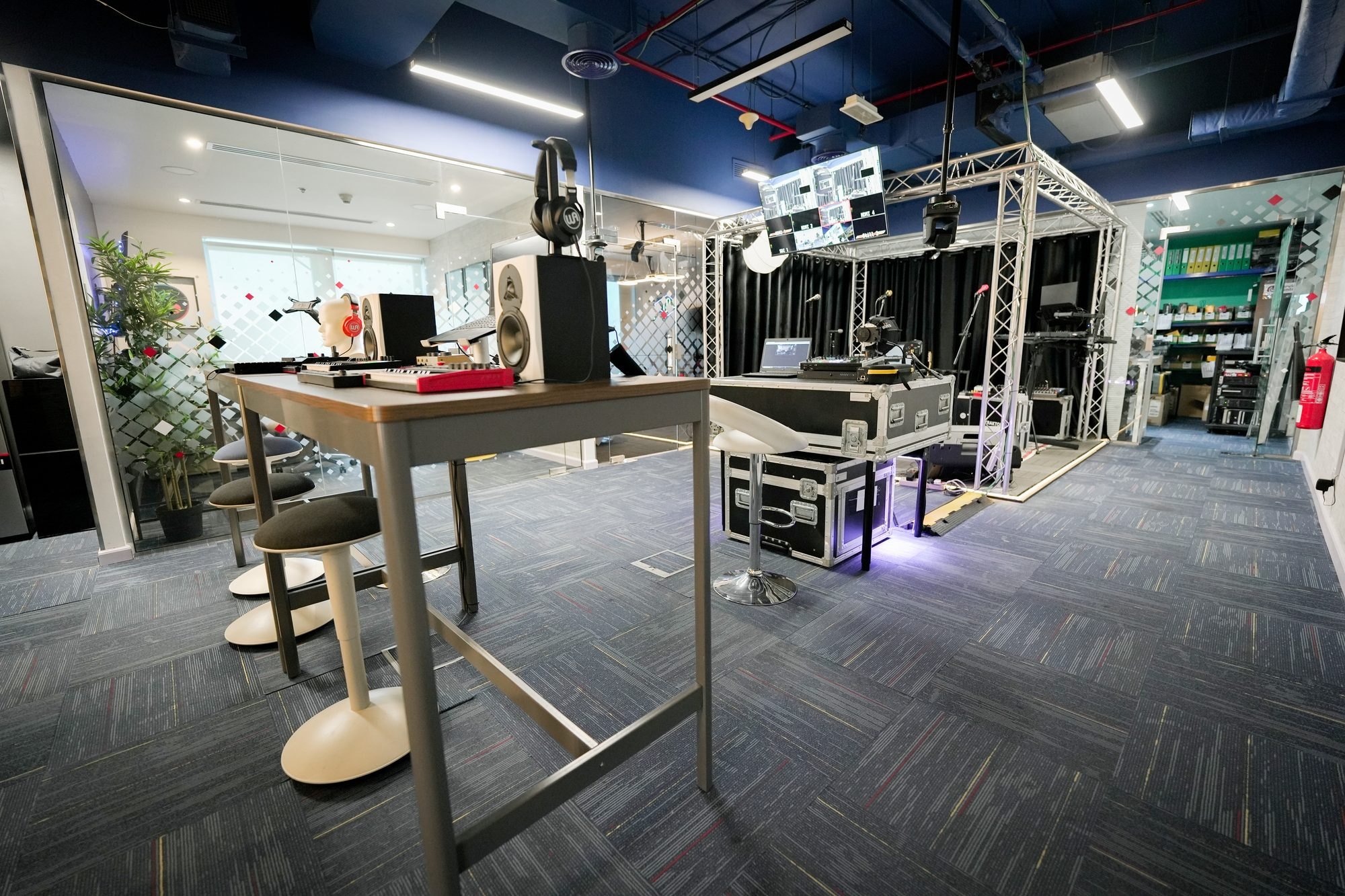 Flight cases and stage gear stacked beside the MCX performance area